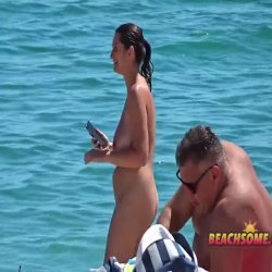 Curvy milf filmed naked on the beach twice letting her big tits swing around